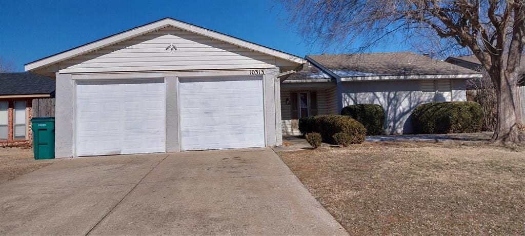 ranch-style home featuring a garage