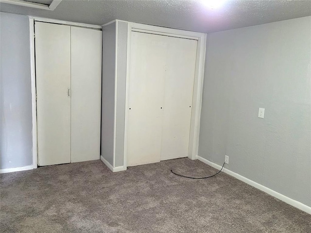 unfurnished bedroom with carpet and a textured ceiling