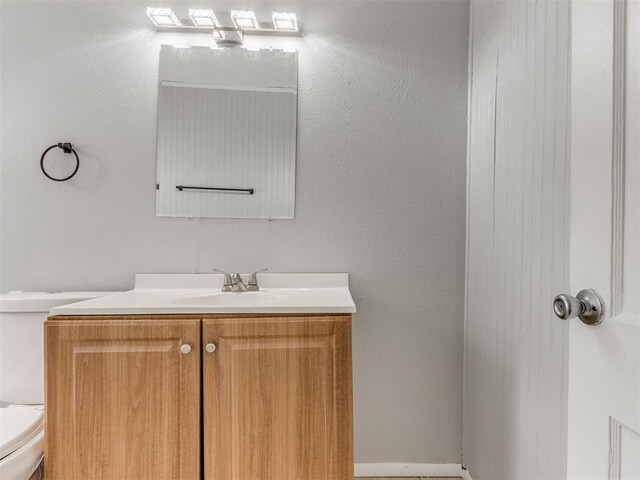 bathroom with toilet and vanity