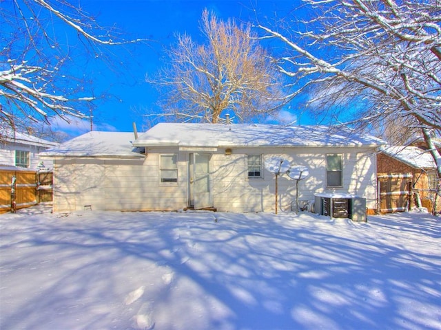 view of snow covered back of property