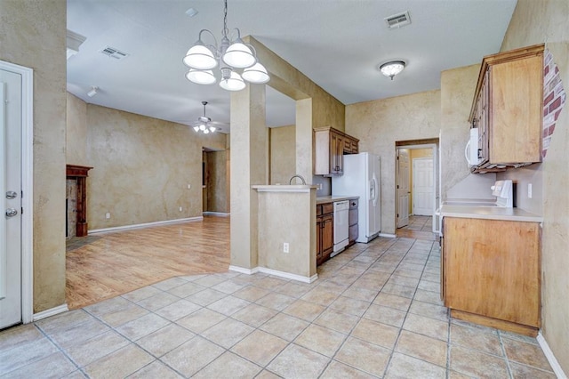 kitchen with ceiling fan with notable chandelier, white appliances, and light tile patterned floors