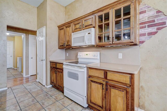 kitchen with white appliances and light tile patterned floors