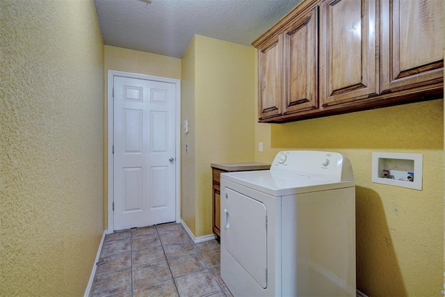 clothes washing area featuring light tile patterned flooring, cabinets, a textured ceiling, and washer / clothes dryer