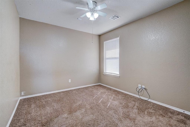 carpeted spare room with ceiling fan