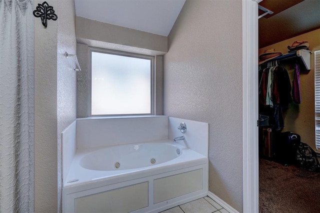 bathroom featuring a bathing tub and tile patterned flooring