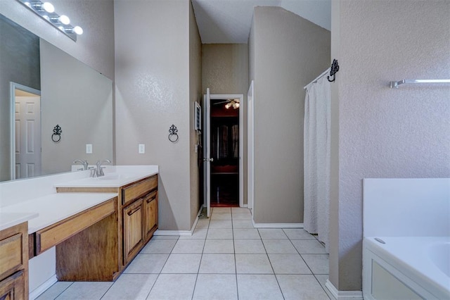 bathroom featuring tile patterned flooring, vanity, a bathing tub, and ceiling fan