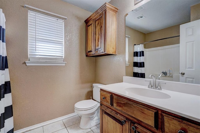 bathroom featuring vanity, tile patterned floors, and toilet