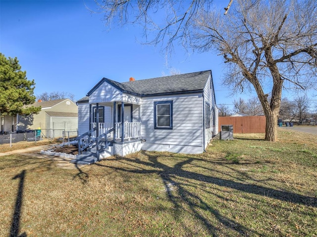 bungalow-style home with a front yard