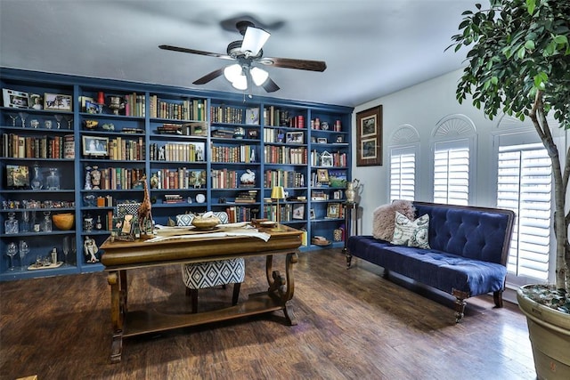 office space with ceiling fan, wood-type flooring, and built in shelves