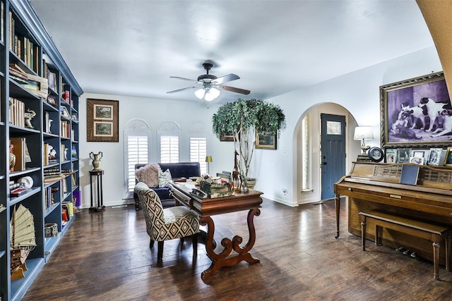 home office with ceiling fan and dark hardwood / wood-style flooring