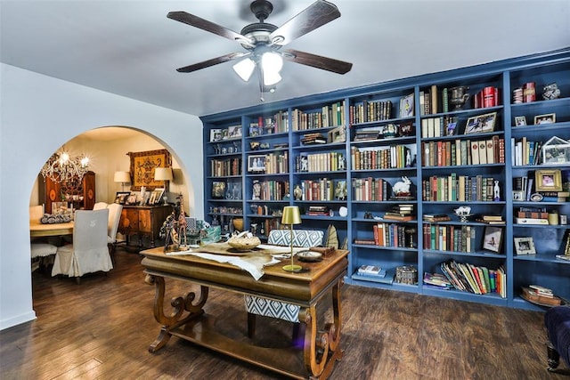 home office featuring hardwood / wood-style flooring, built in shelves, and ceiling fan