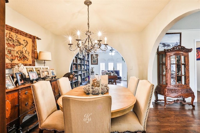 dining area featuring dark wood-type flooring and a chandelier