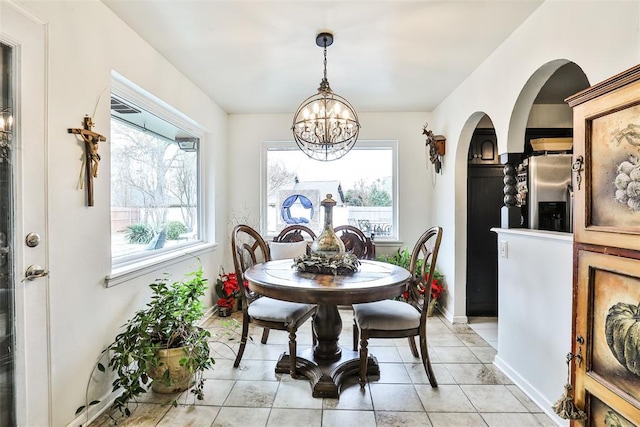 dining room with light tile patterned flooring and a chandelier