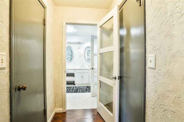 hall featuring dark hardwood / wood-style floors and sink