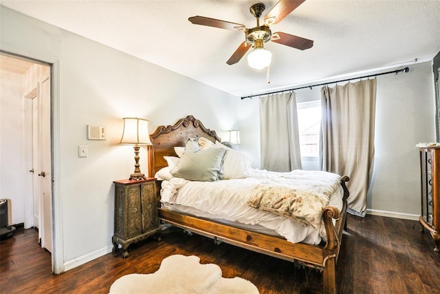 bedroom with ceiling fan and dark hardwood / wood-style floors