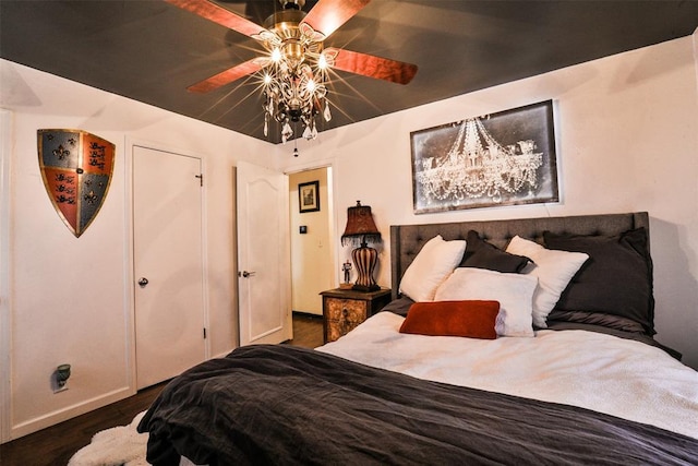 bedroom with ceiling fan and dark hardwood / wood-style floors