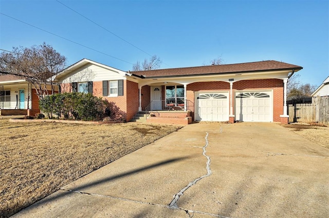 single story home with covered porch, a front lawn, and a garage