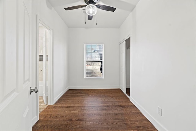 unfurnished bedroom featuring ceiling fan and dark hardwood / wood-style flooring