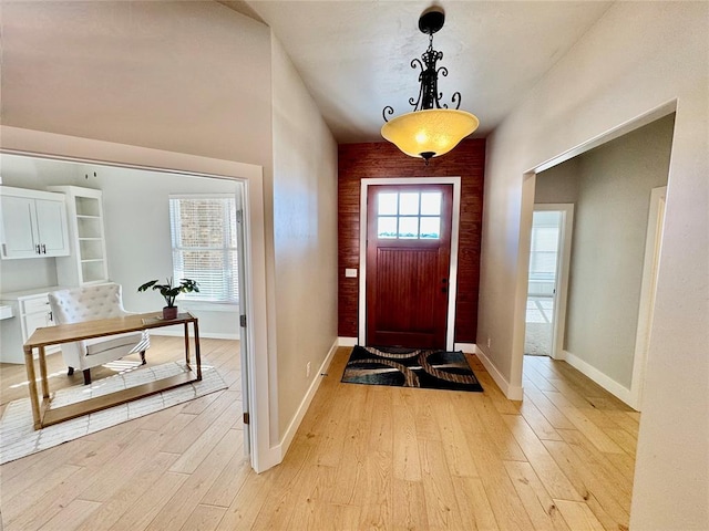 entryway with a wealth of natural light and light hardwood / wood-style flooring