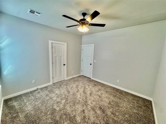 empty room featuring carpet floors and ceiling fan