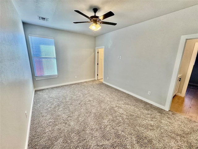 carpeted empty room with ceiling fan