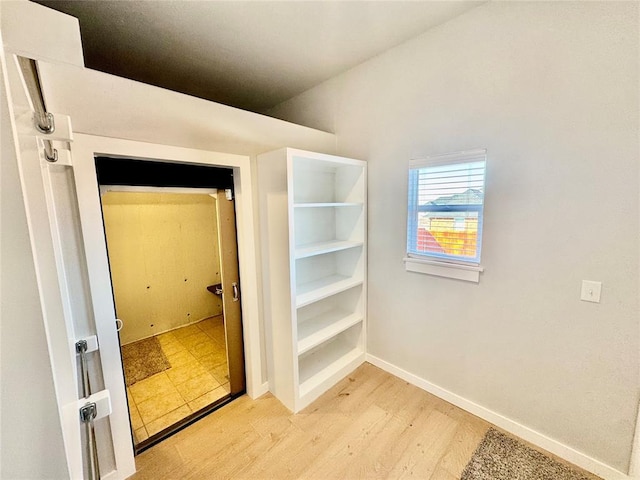 walk in closet with hardwood / wood-style flooring