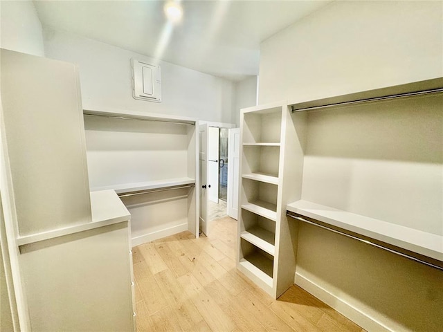 spacious closet with light hardwood / wood-style floors