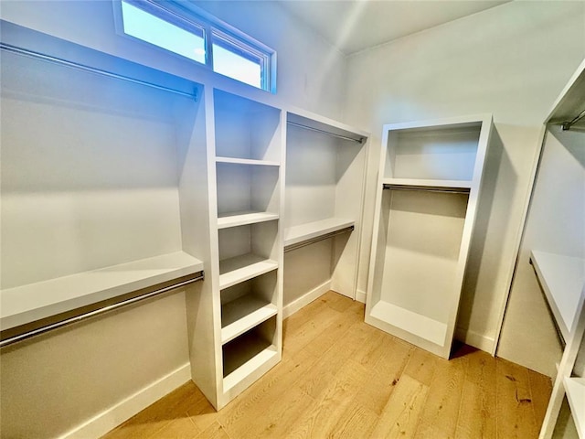 walk in closet featuring light hardwood / wood-style flooring