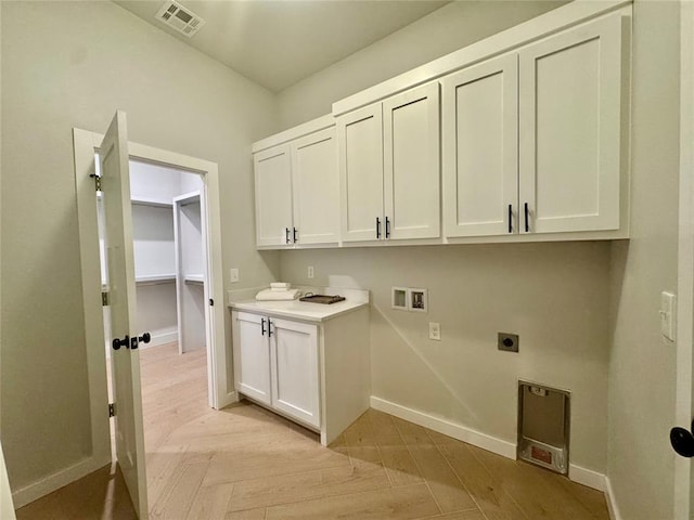 laundry area featuring light parquet flooring, washer hookup, cabinets, and hookup for an electric dryer