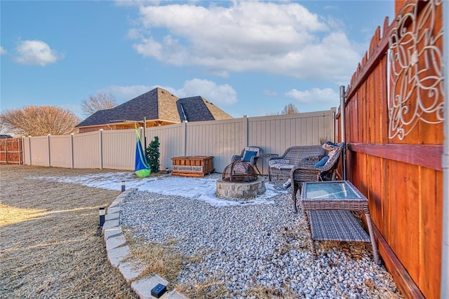 view of yard with a fenced backyard and a fire pit