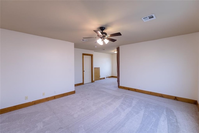 unfurnished room with light carpet, ceiling fan, visible vents, and baseboards