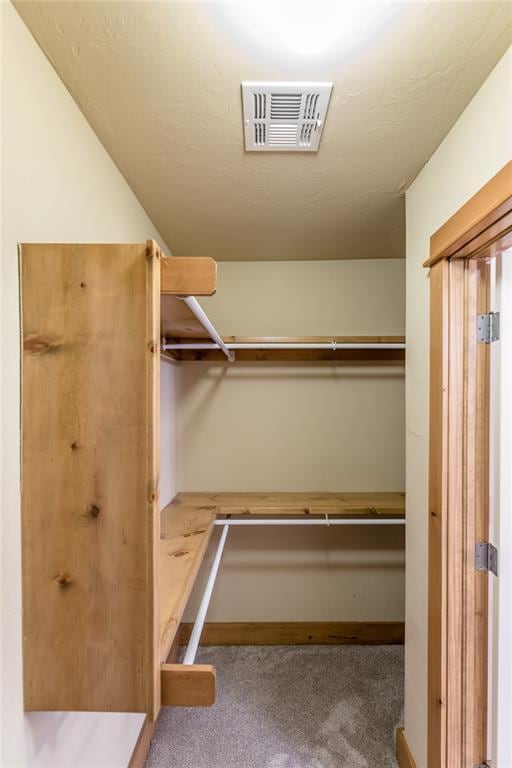 walk in closet featuring carpet floors and visible vents