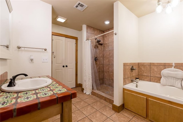 full bathroom with vanity, visible vents, a shower stall, a bath, and tile patterned floors