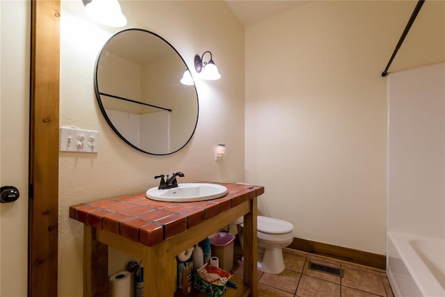 bathroom with visible vents, baseboards, toilet, tile patterned flooring, and vanity