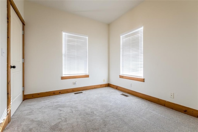 unfurnished room featuring carpet floors, baseboards, and visible vents