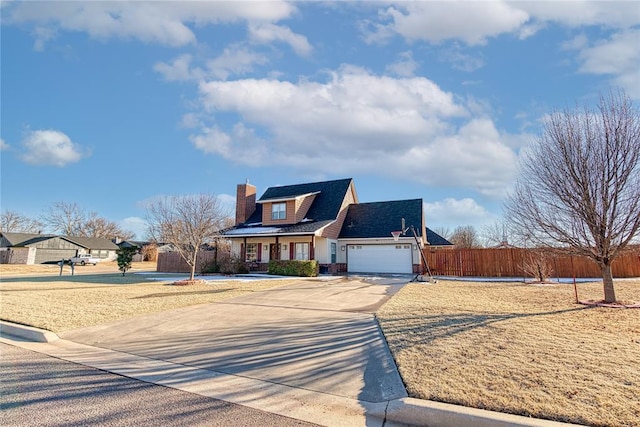 view of front of house with a garage, driveway, a chimney, and fence