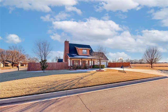 view of front of house featuring a chimney, a porch, fence, a garage, and driveway