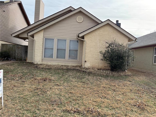 view of side of property with a yard