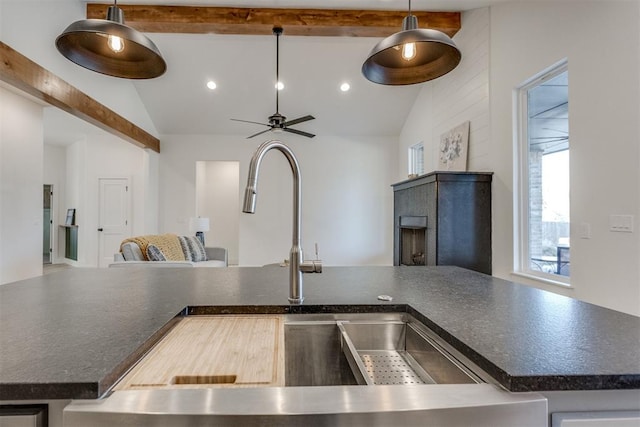 kitchen with ceiling fan, sink, pendant lighting, and vaulted ceiling