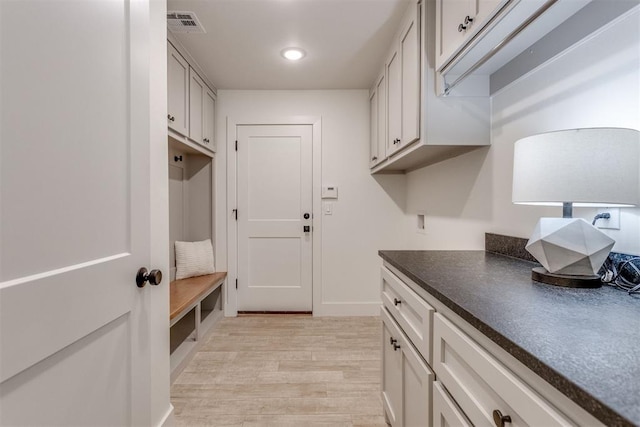 interior space with cabinets and light hardwood / wood-style flooring