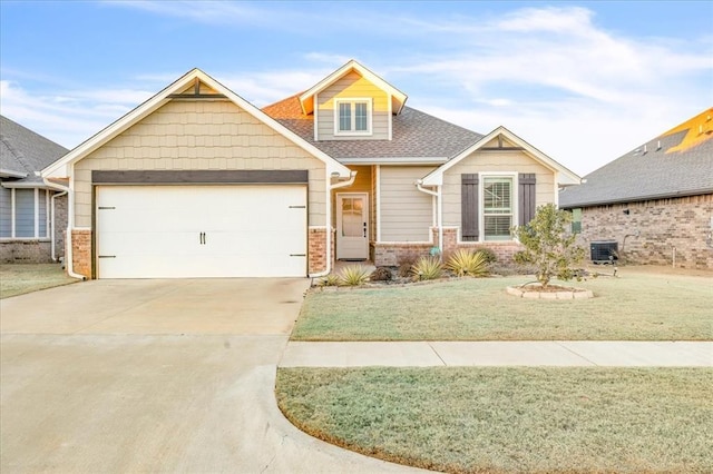 craftsman inspired home featuring central AC unit, a garage, and a front lawn