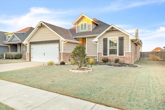 craftsman-style house featuring a front lawn and a garage