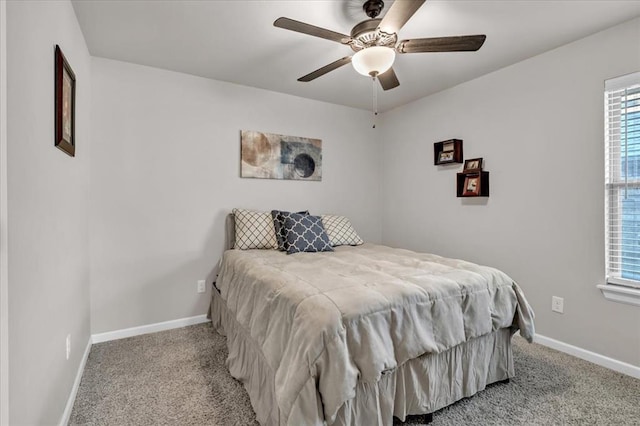 bedroom with ceiling fan, light carpet, and multiple windows