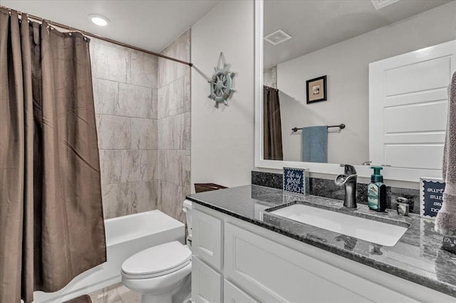 full bathroom with vanity, shower / bath combo, and toilet