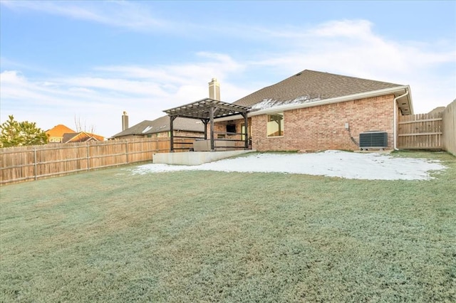 view of yard with central AC unit and a pergola