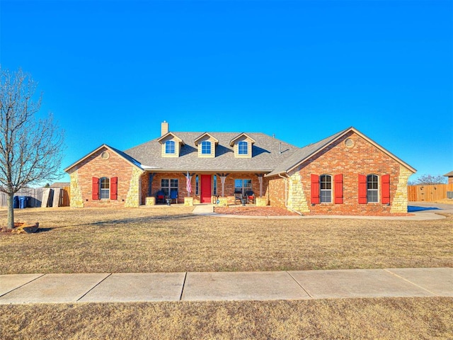 view of front of property with a front yard and covered porch