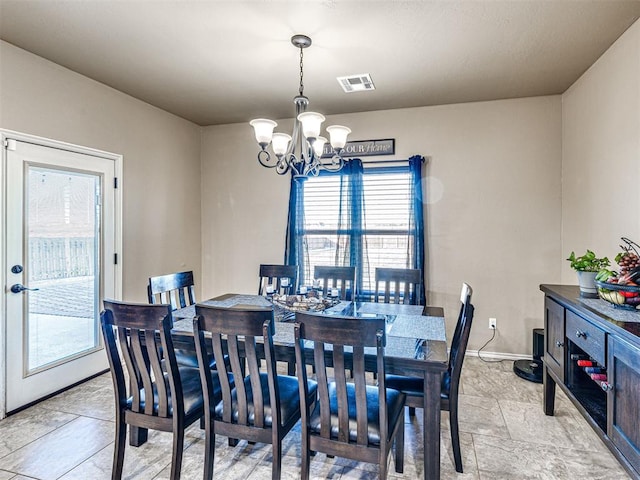 dining area with an inviting chandelier