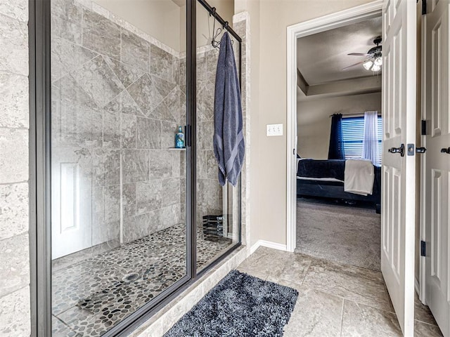 bathroom featuring a shower with door and ceiling fan