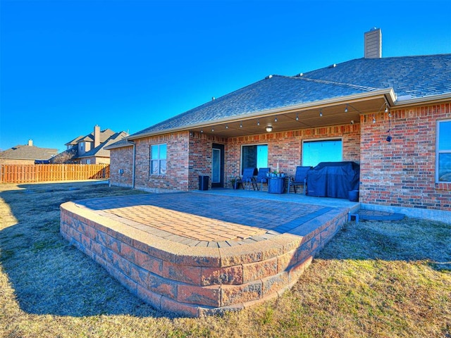 rear view of house with a yard and a patio area