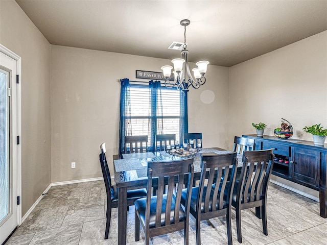 dining room with visible vents, baseboards, and a notable chandelier